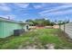 Spacious backyard with patio and partial fencing, offering plenty of room for outdoor activities at 1530 Clair Mel Cir, Tampa, FL 33619