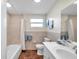 Bathroom featuring tile accents, a large mirror, and a combination shower and tub at 1530 Clair Mel Cir, Tampa, FL 33619