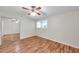 This bedroom features wood floors, a ceiling fan, and a closet with mirrored doors at 1530 Clair Mel Cir, Tampa, FL 33619