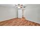 This bedroom features wood floors, a ceiling fan, and an adjacent room at 1530 Clair Mel Cir, Tampa, FL 33619