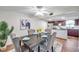 Elegant dining room with modern table set and view of the kitchen, creating an ideal space for Gathering meals at 1530 Clair Mel Cir, Tampa, FL 33619