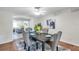 Stylish dining room connected to the living area, featuring modern decor and ample seating for Gathering dinners at 1530 Clair Mel Cir, Tampa, FL 33619