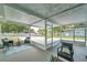 Screened-in porch with neutral decor provides a relaxing view of the neighborhood at 1530 Clair Mel Cir, Tampa, FL 33619