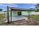 View of a shed featuring a concrete pad, adjacent to the home, with an open garage door at 1530 Clair Mel Cir, Tampa, FL 33619