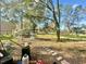 Large, tree-filled backyard with a chicken coop and stepping stones, offering a peaceful rural setting at 18840 Rustic Woods Trl, Odessa, FL 33556