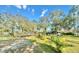 Expansive backyard with lush greenery and mature trees providing ample shade and privacy at 18840 Rustic Woods Trl, Odessa, FL 33556