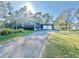 View of home with an attached 2 car garage and nice landscaping at 18840 Rustic Woods Trl, Odessa, FL 33556