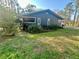 Exterior view of home with mature landscaping and screened in porch at 18840 Rustic Woods Trl, Odessa, FL 33556