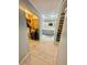 View of hallway with closet and bathroom featuring dual vanity and decorative tile floor at 18840 Rustic Woods Trl, Odessa, FL 33556