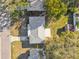 Aerial view of a home with a well-manicured lawn, and mature trees at 2008 Harvard Ave, Dunedin, FL 34698