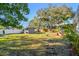 Expansive, well-maintained backyard with mature trees and a storage shed at 2008 Harvard Ave, Dunedin, FL 34698