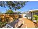 Large wooden deck with an outdoor dining set in a fenced backyard at 2008 Harvard Ave, Dunedin, FL 34698