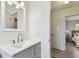 Well-lit bathroom with a gray vanity, modern fixtures, and neutral tones at 2008 Harvard Ave, Dunedin, FL 34698