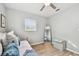 Bedroom with a daybed, mirror, and light gray walls, complemented by wood-look flooring and ample natural light at 2008 Harvard Ave, Dunedin, FL 34698