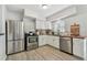 Bright kitchen features white cabinets, wood countertops, stainless steel appliances, and wood-look flooring at 2008 Harvard Ave, Dunedin, FL 34698