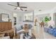 Bright living room with modern furnishings, a ceiling fan, and an open view into kitchen and dining areas at 2008 Harvard Ave, Dunedin, FL 34698