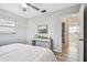 Cozy bedroom with light gray walls, wood-look flooring, and access to an ensuite bathroom at 2008 Harvard Ave, Dunedin, FL 34698