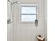 Shower with white subway tile, silver fixtures, and a bright window at 2008 Harvard Ave, Dunedin, FL 34698