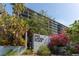 Exterior view of One Laurel Place with lush landscaping and blooming flowers surrounding the entrance sign at 201 W Laurel St # 507, Tampa, FL 33602