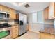 Bright kitchen with granite countertops, stainless steel appliances, wood cabinets, and a window at 201 W Laurel St # 507, Tampa, FL 33602