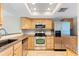 Well-lit kitchen featuring stainless steel appliances, wood cabinets, and granite countertops at 201 W Laurel St # 507, Tampa, FL 33602