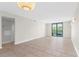 Bright living room with tiled flooring, modern lighting, and large sliding doors to the outdoor balcony at 201 W Laurel St # 507, Tampa, FL 33602