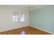 Bedroom with hardwood floors, 2 windows, and bright walls at 2101 Sunset Point Rd # 1003, Clearwater, FL 33765