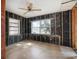 Spacious living room featuring tile flooring, exposed framing and two windows that bring in natural light at 2460 Baywood E Dr, Dunedin, FL 34698