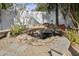 Backyard pond with rock features, lush foliage, and stone benches creating a serene outdoor space at 2460 Baywood E Dr, Dunedin, FL 34698