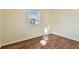 Cozy bedroom featuring a window with blinds and wood-look flooring throughout at 270 41St Ne Ave, St Petersburg, FL 33703