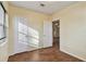 Bright bedroom features wood-look flooring, a window with blinds, and a closet for storage at 270 41St Ne Ave, St Petersburg, FL 33703