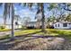 Single-story home nestled among mature trees, featuring a covered entrance and a neatly manicured lawn at 270 41St Ne Ave, St Petersburg, FL 33703