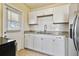 Modern kitchen showcasing white subway tile backsplash, granite counters and white cabinets at 270 41St Ne Ave, St Petersburg, FL 33703