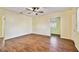 Spacious living room featuring wood-look floors, ceiling fan, and bright, light yellow walls at 270 41St Ne Ave, St Petersburg, FL 33703