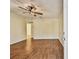 Bright living room featuring a ceiling fan, light yellow walls, and wood-look tile flooring at 270 41St Ne Ave, St Petersburg, FL 33703