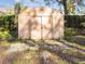 Outdoor storage shed with double doors, sitting on stone pads, surrounded by greenery at 270 41St Ne Ave, St Petersburg, FL 33703