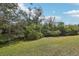 Wide shot of the backyard with trees around the house at 2725 Countryside Blvd # 103, Clearwater, FL 33761