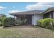 Exterior view of a home featuring a screened lanai and partial lawn at 2725 Countryside Blvd # 103, Clearwater, FL 33761