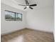 Bright bedroom featuring wood-look tile flooring and a window with a view at 2725 Countryside Blvd # 103, Clearwater, FL 33761