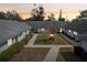 Inviting courtyard view featuring a manicured lawn, walkway, and a charming central tree and landscape lighting at 2725 Countryside Blvd # 103, Clearwater, FL 33761