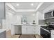 This well-lit kitchen has stainless steel appliances and white countertops at 2725 Countryside Blvd # 103, Clearwater, FL 33761