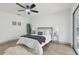 Comfortable main bedroom with wood-look tile floors, ceiling fan, and stylish decor at 2725 Countryside Blvd # 103, Clearwater, FL 33761