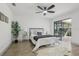 Well-lit main bedroom with wood-look tile floors, ceiling fan, and sliding glass doors at 2725 Countryside Blvd # 103, Clearwater, FL 33761