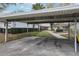 Assigned covered parking spot with landscaping and walkways to the homes at 2725 Countryside Blvd # 103, Clearwater, FL 33761