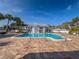 A lovely pool with nice blue water surrounded by greenery and palm trees at 2725 Countryside Blvd # 103, Clearwater, FL 33761