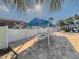 Shaded seating area by the pool with tables, chairs, and a blue awning at 2725 Countryside Blvd # 103, Clearwater, FL 33761