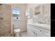 Bright bathroom with white cabinets, decorative vanity, updated fixtures, modern tiling, and a shower-tub combination at 3017 Sanchez St # 1/2, Tampa, FL 33605