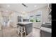 Modern kitchen featuring gray and white cabinets, an island with a white countertop, pendant lighting, and stainless steel appliances at 3017 Sanchez St # 1/2, Tampa, FL 33605