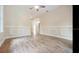 Living room featuring hardwood floors, wainscoting, natural light, and a ceiling fan at 3017 Sanchez St # 1/2, Tampa, FL 33605