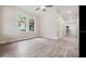 Living room featuring hardwood floors, wainscoting, natural light, and an arched doorway at 3017 Sanchez St # 1/2, Tampa, FL 33605